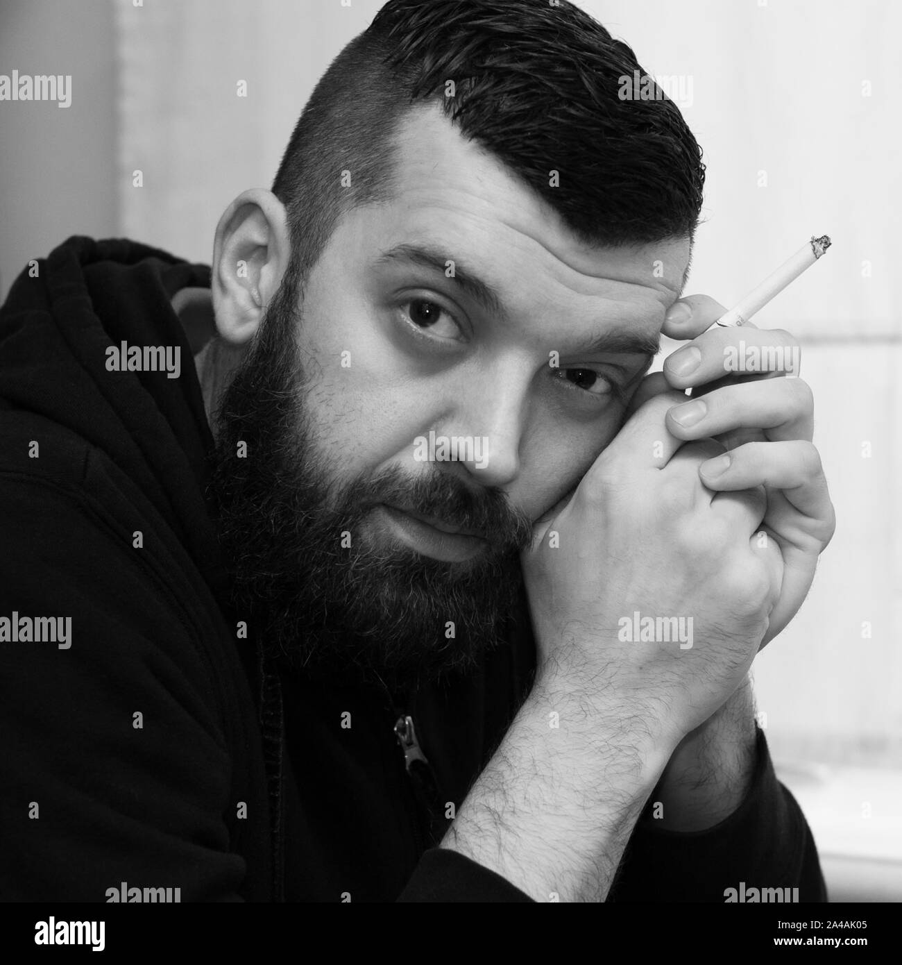 Man smoking cigarette in restaurant Black and White Stock Photos