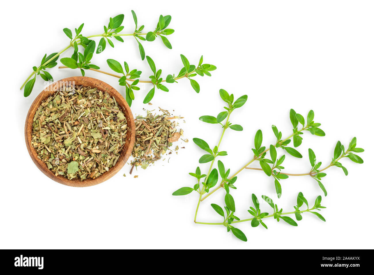 Dried thyme leaves in the wooden bowl, with fresh thyme isolated on