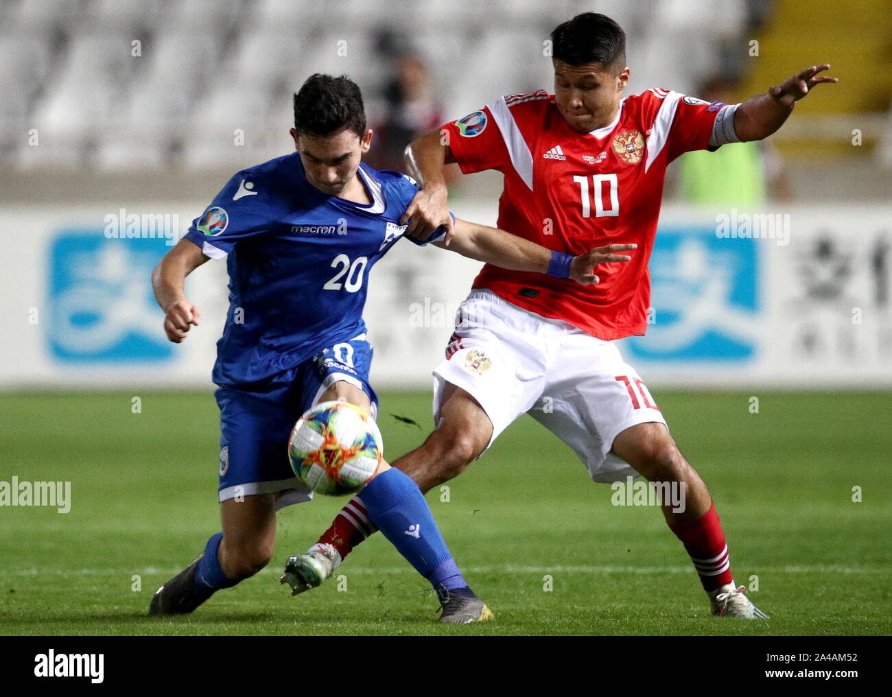 Cyprus. 13th Oct, 2019. NICOSIA, CYPRUS - OCTOBER 13, 2019: Cyprus' Ioannis  Kosti (L) and Russia's Ilzat Akhmetov fight for the ball in the 2020 UEFA  Euro Qualification Round Group I football