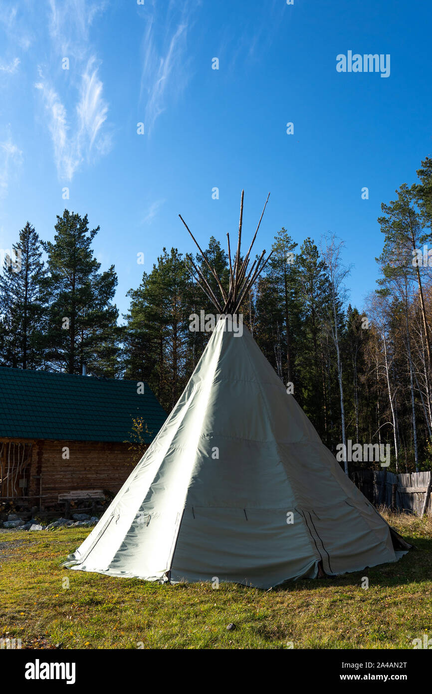 Native American wigwam in the forest. Modern material for the manufacture of wigwam. Yurt is the home of the northern peoples Stock Photo