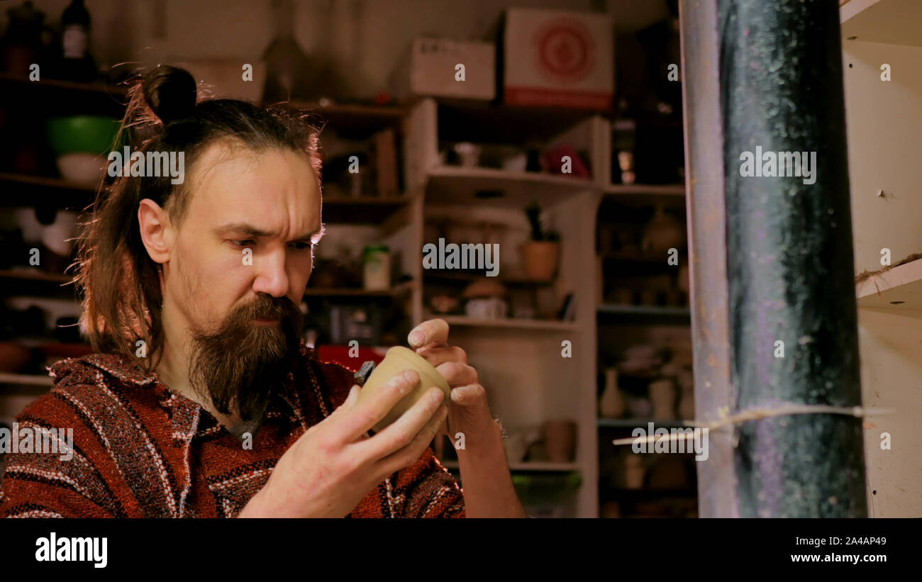 Professional male potter working in workshop, studio Stock Photo