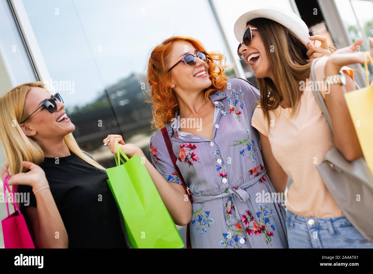 Beautiful women with shopping bags walking at the mall Stock Photo - Alamy