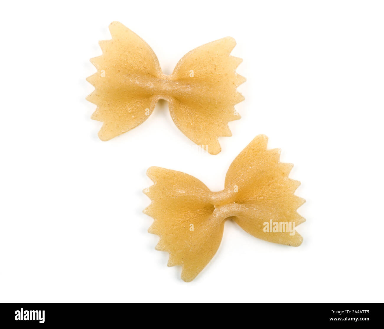 Farfalle italian bow tie shape pasta macro view two particles isolated on white background with clipping path Stock Photo