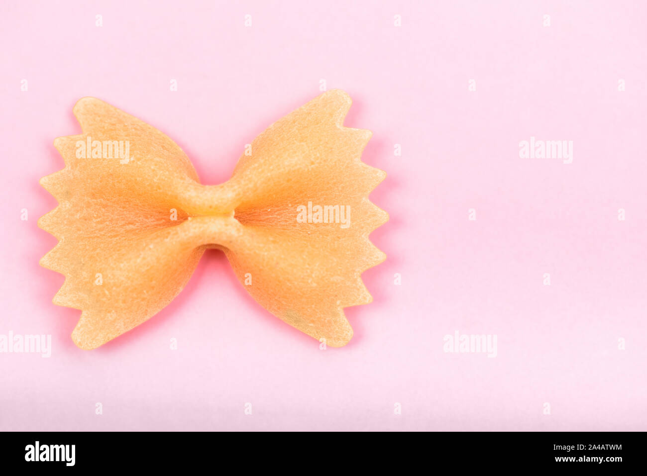Farfalle tie bow shaped pasta macro on pink background isolated with clipping path Stock Photo