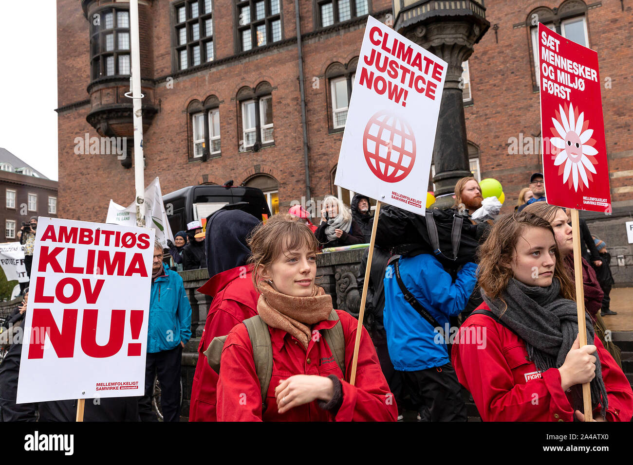 COPENHAGEN, DENMARK – OCTOBER 11, 2019:  Thousands of people gather at a People’s Climate March at Copenhagen City Hall Square and demanded swift and extensive climate action, which marks the conclusion of the C40 World Mayors Summit during this week in Copenhagen.  To the left a sign with the text in English: ‘Ambitious climate law now’. This refers to a popular demand for a statutory framework condition for the Danish Governments climate efforts, which includes obligations to define binding climate goals. Stock Photo