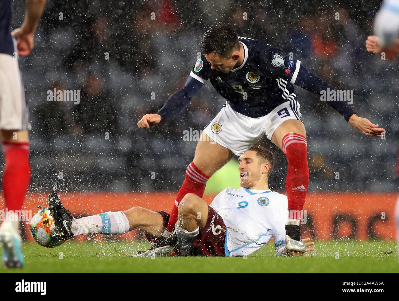Scotland's Lawrence Shankland (top) and San Marino's Marcello Mularoni battle for the ball during the UEFA Euro 2020 qualifying match at Hampden Park, Glasgow. Stock Photo