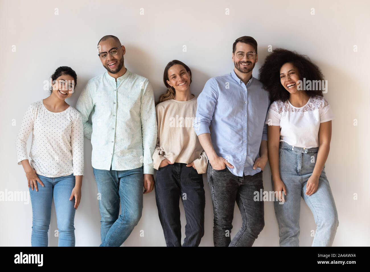 Portrait of smiling young diverse people standing in row Stock Photo ...