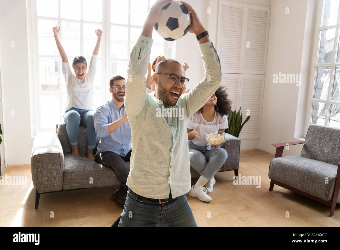 Excited African American man celebrating favorite football team goal