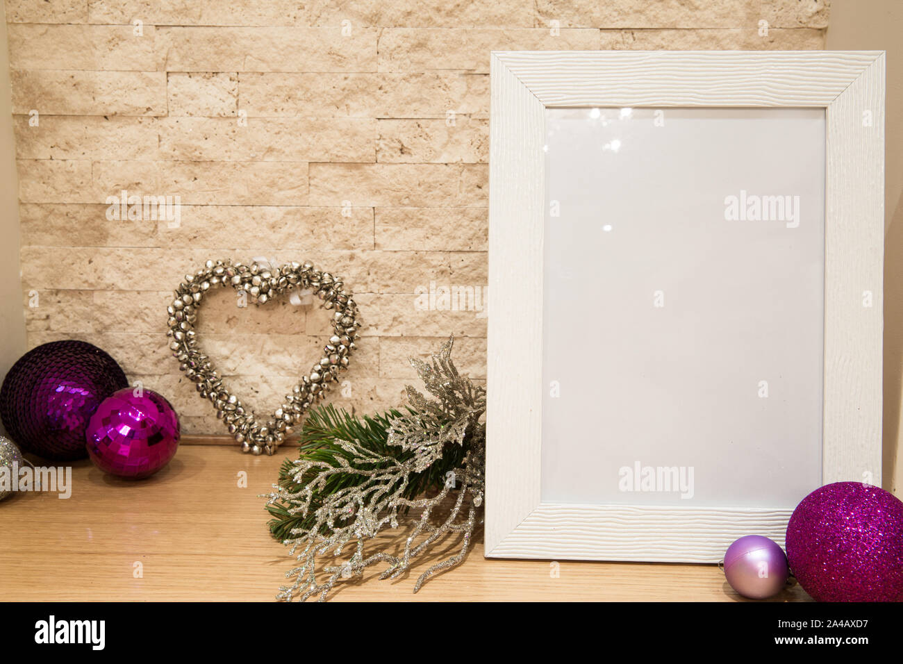 Christmas mock up, violet and siler Christmas decoration. Fir branc and silver heart decoration. Colorful violet and purple Christmas balls. Stock Photo