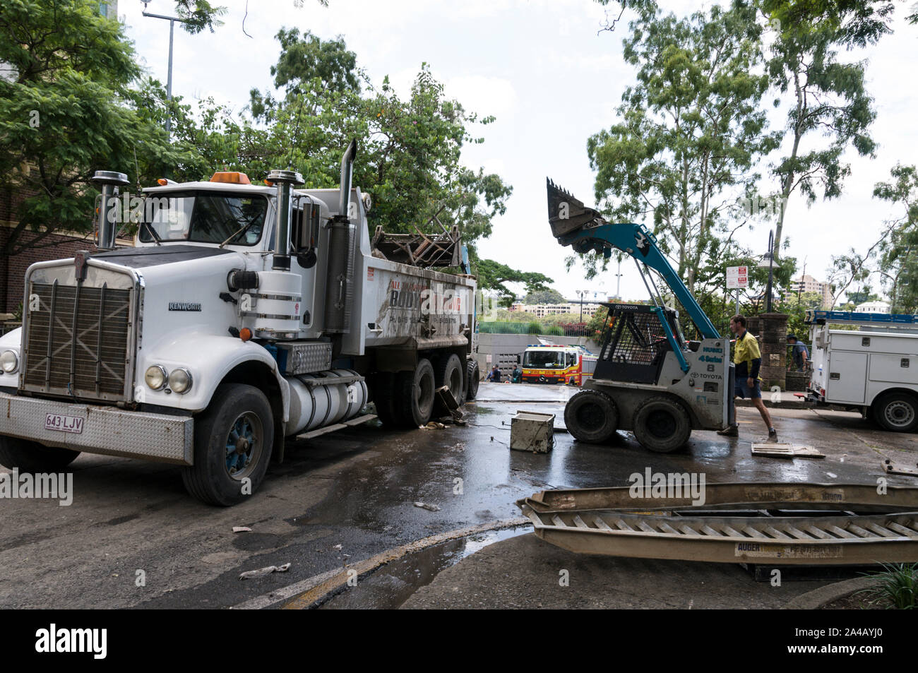 A forklift truck loading flood damaged equipment onto a waiting
