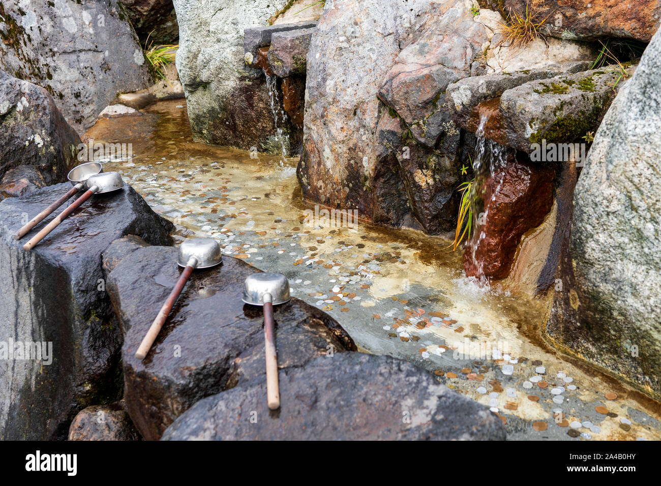 Ladles Or Dipper And Drinkable Water Source Pool Full Of Coins. Stock Photo