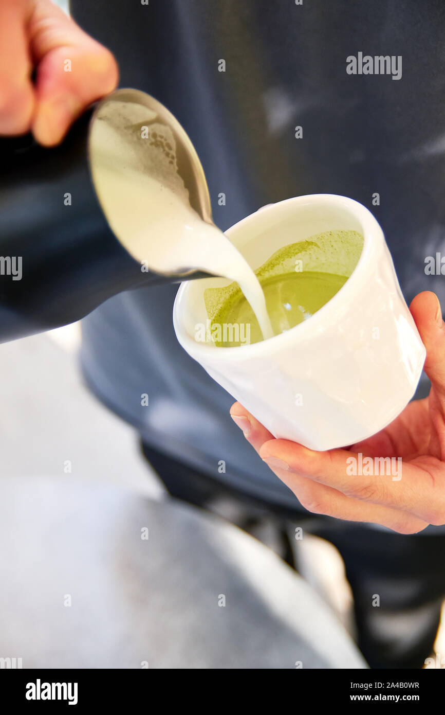 https://c8.alamy.com/comp/2A4B0WR/male-barista-making-vegan-matcha-cappuccino-with-oat-milk-with-latte-art-in-outdoor-cafe-2A4B0WR.jpg