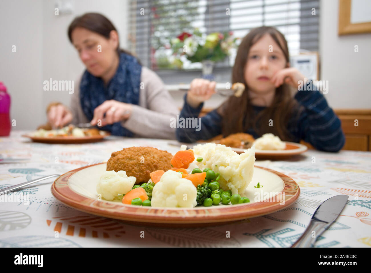 Child eating at the dinner table Stock Photo