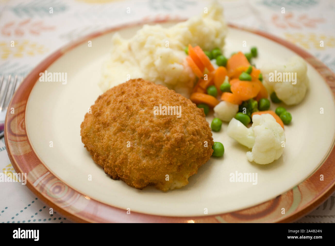Chicken Kiev with potato and vegetables Stock Photo