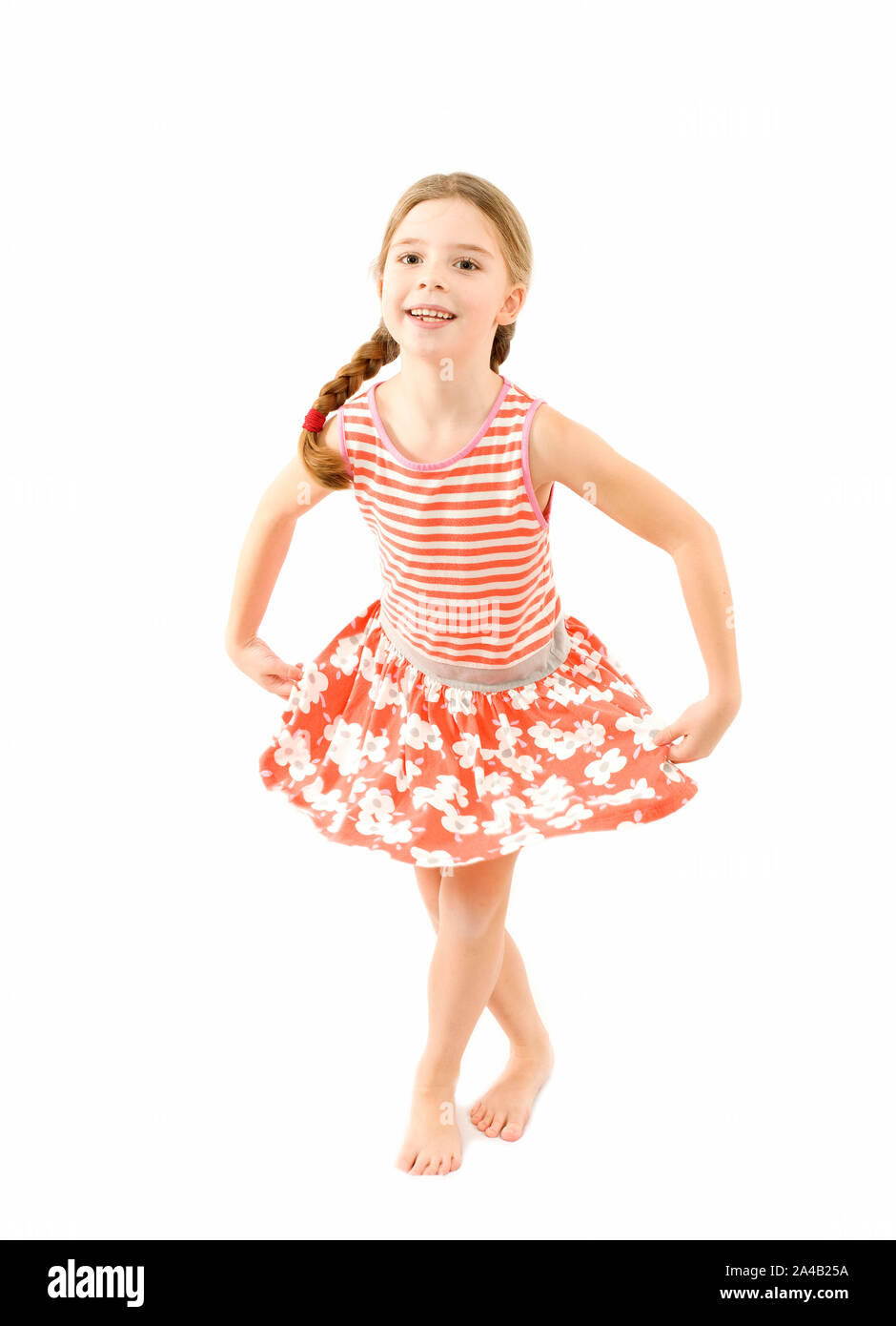 Young girl curtsying to the camera on isolated white background Stock Photo