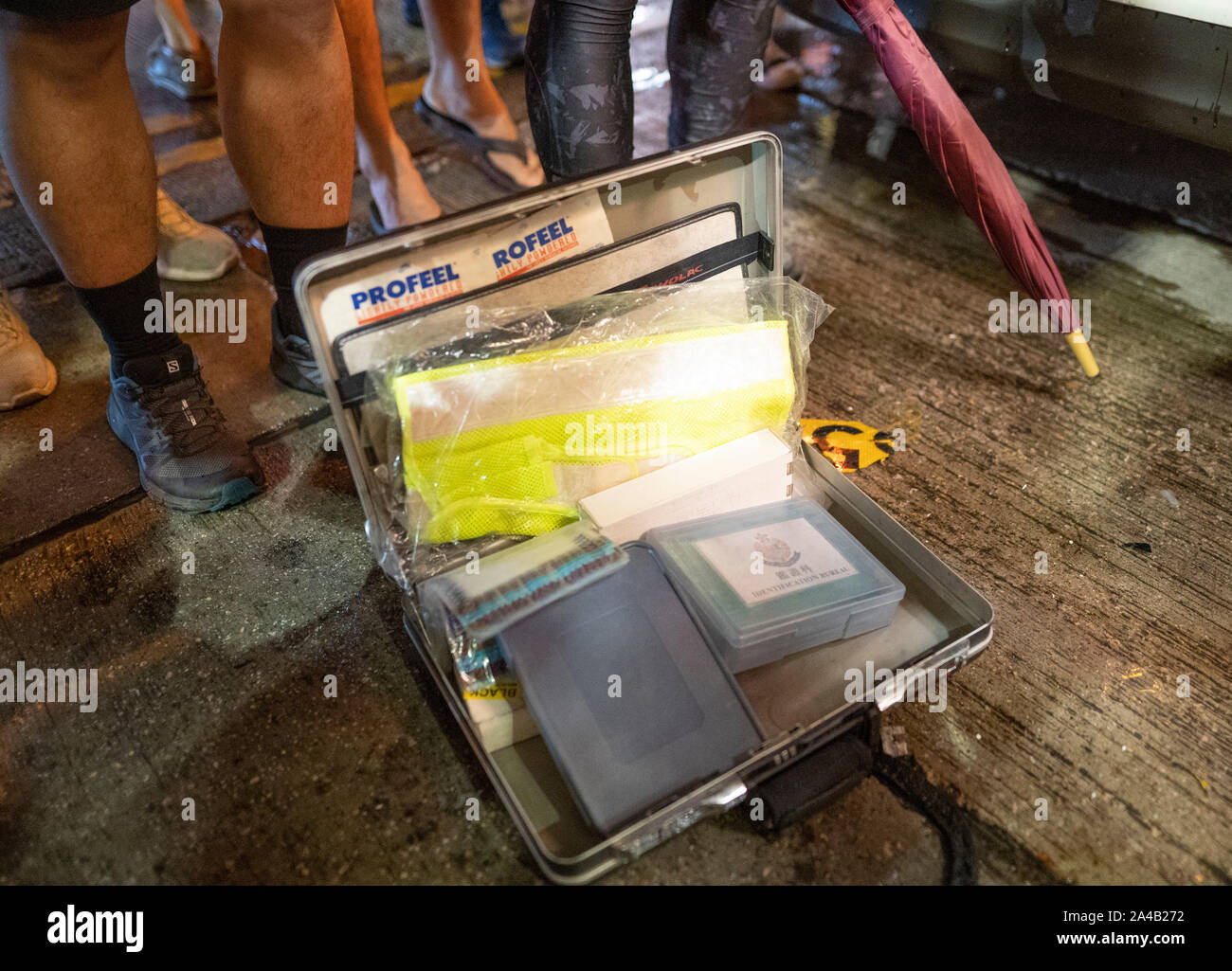 Hong Kong, China. 13th October 2019. Riot police on Nathan Road in Mongkok district in Kowloon on Sunday evening. This incident was one of several throughout Hong Kong on Sunday which saw acts of vandalism carried out by a minority in the pro-democracy movement. Police briefcase taken from vandalised unmarked police car . Iain Masterton/Alamy Live News. Stock Photo