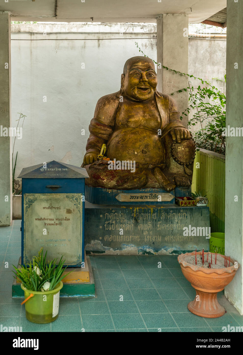 Bang Saen, Thailand - March 16, 2019: Wang Saensuk Buddhist Monastery. Gilded laughing happy Buddha statue is presented as Phra Sankajayana, god of Lu Stock Photo
