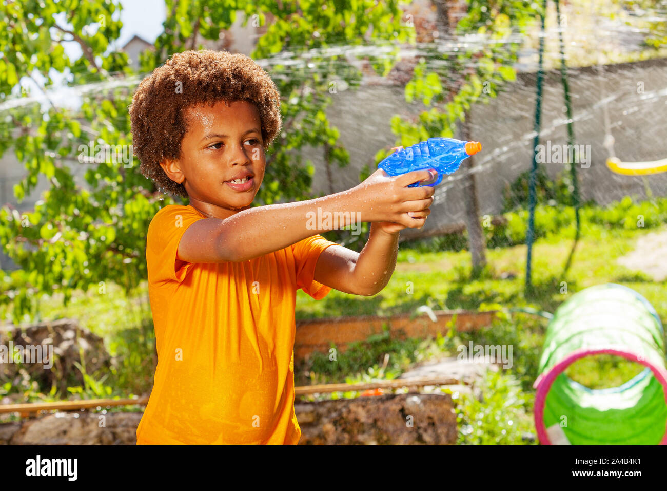 Boy playing water gun fight game with his friends Stock Photo Alamy
