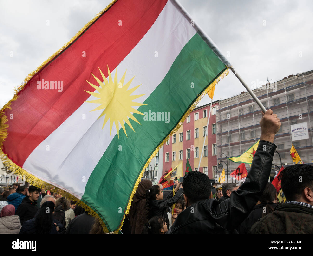 Berlin/Germany: Demostration and protest against Turkish offensive and aggressions in Syria against the Kurds, large Kurdistan flag in the foreground Stock Photo