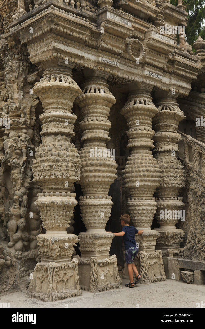 Young visitor in front of the entrance to the Ideal Palace (Le Palais idéal) designed by French postman Ferdinand Cheval and build from 1876 to 1912 in Hauterives, France. ATTENTION: This image is a part of a photo essay of 36 photos featuring the Ideal Palace (Le Palais idéal). Stock Photo