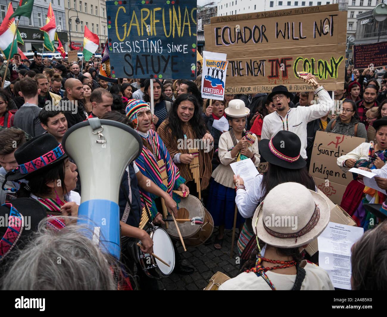 Demostration and protest against President Moreno's politics in Ecuador, crowd of people in traditional clothes showing banners while playing music Stock Photo