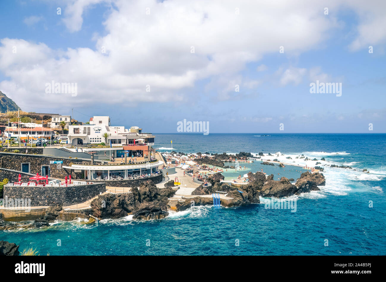 Porto Moniz, Madeira, Portugal - Sep 13, 2019: Natural swimming pools in the Atlantic ocean waters. Surrounded by rocks from the open sea. Popular tourist place on the amazing Portuguese island. Stock Photo