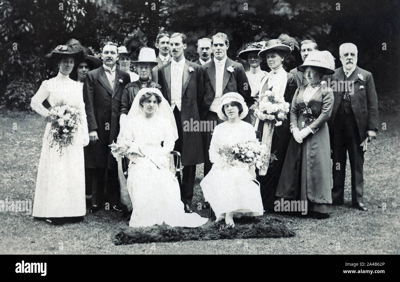 Archival photograph of a wedding party outdoors circa 1913 showing 16 people. Stock Photo