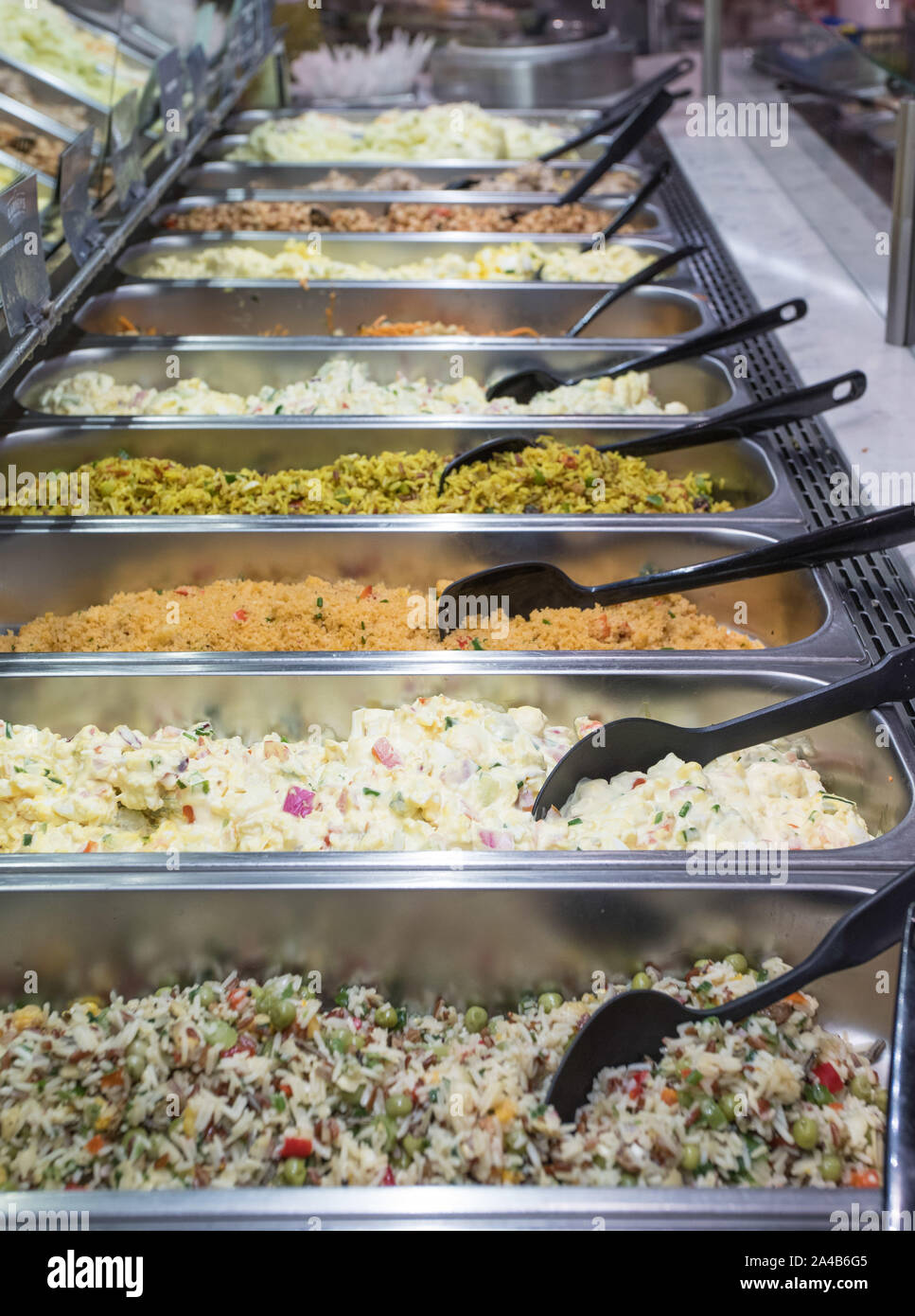 Sideways view of trays of various types of salads at a salad bar in a