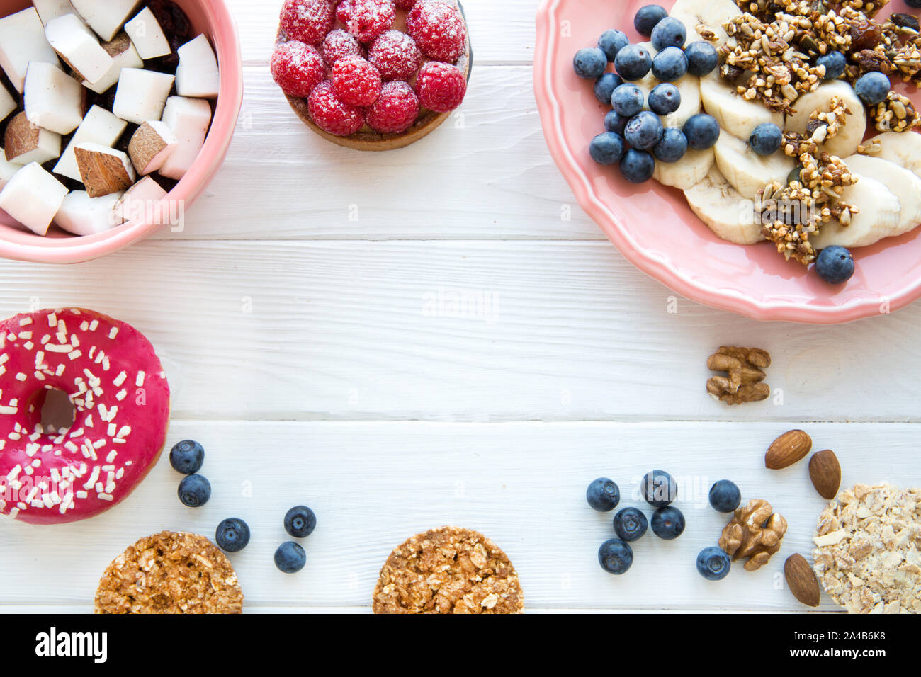 Healthy crunchy cookies and granola, banana and coconut pieces, pink