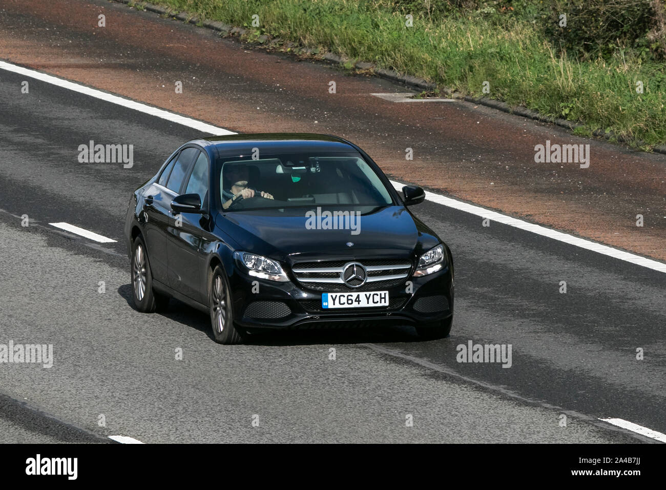 2014 black Mercedes-Benz C220 SE Executive Bluetec; traveling on the M6 motorway near Preston in Lancashire, UK Stock Photo