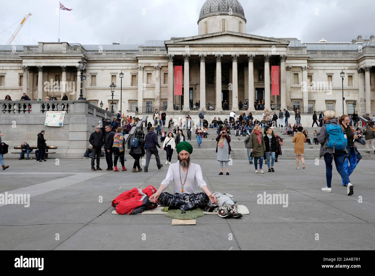 A man meditating in Trafalgar Square, London Stock Photo