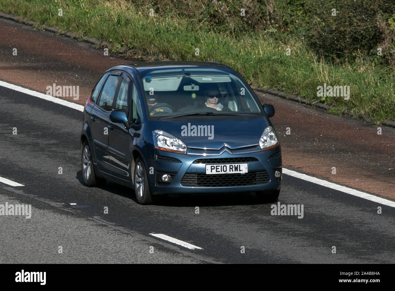 2010 blue Citroën C4 Picasso Vtr+ HDI; traveling on the M6 motorway near Preston in Lancashire, UK Stock Photo