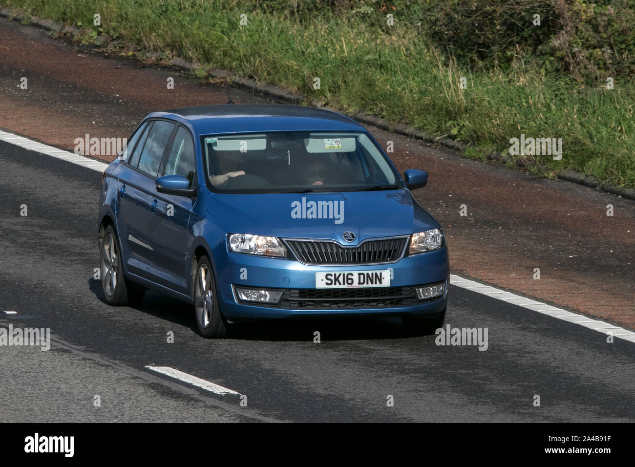 2016 blue Škoda Rapid Spaceback SE Tech T; traveling on the M6 motorway near Preston in Lancashire, UK Stock Photo