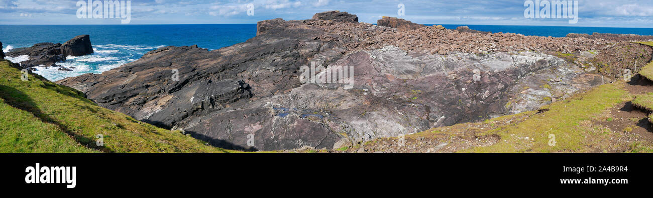Unst Rocks Coast rock formations showing rock debris deposited at the top of the ...