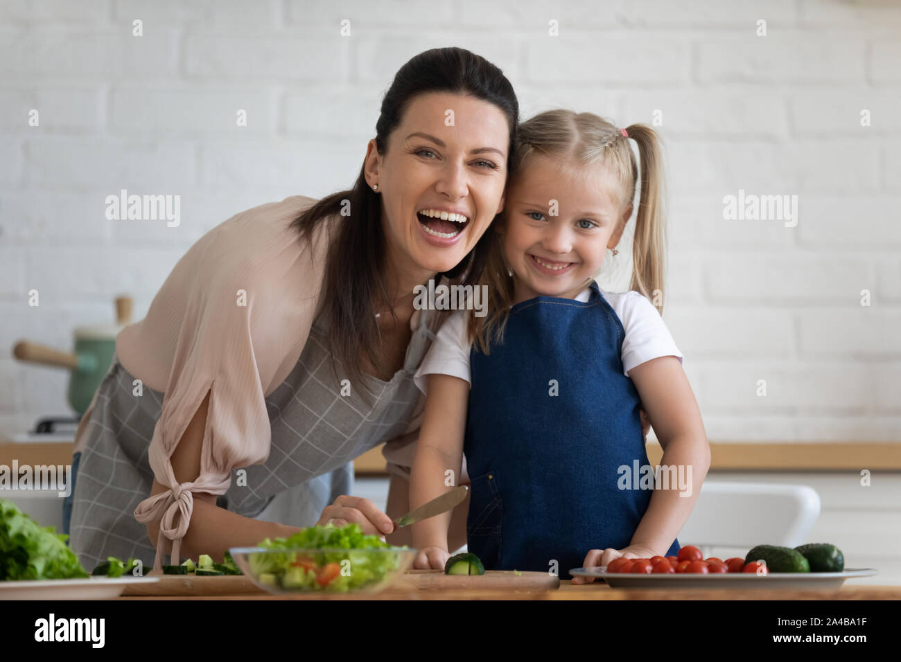 Head shot portrait excited mother and little daughter in kitchen Stock ...