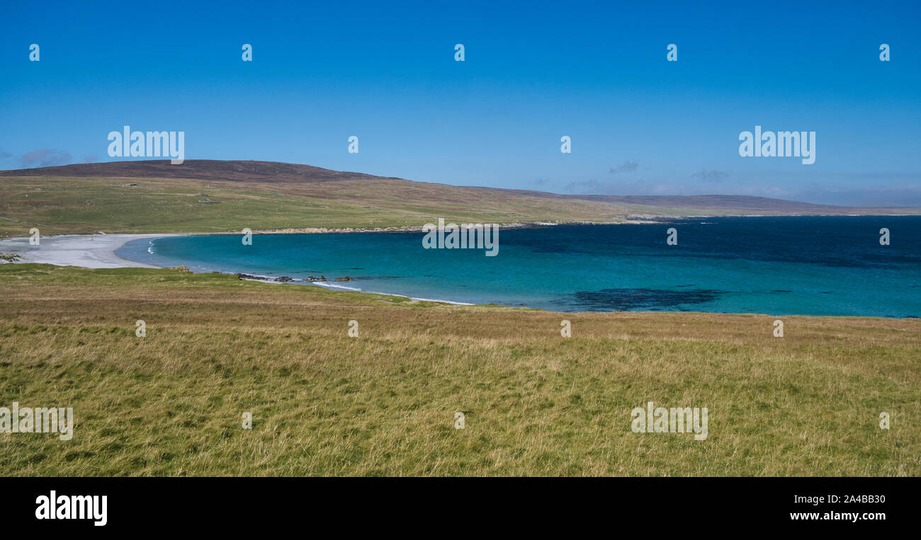The white sand and blue sea at Sandwick on the island of Unst in Shetland, Scotland, UK - an idyllic, unspoiled, remote beach. Stock Photo