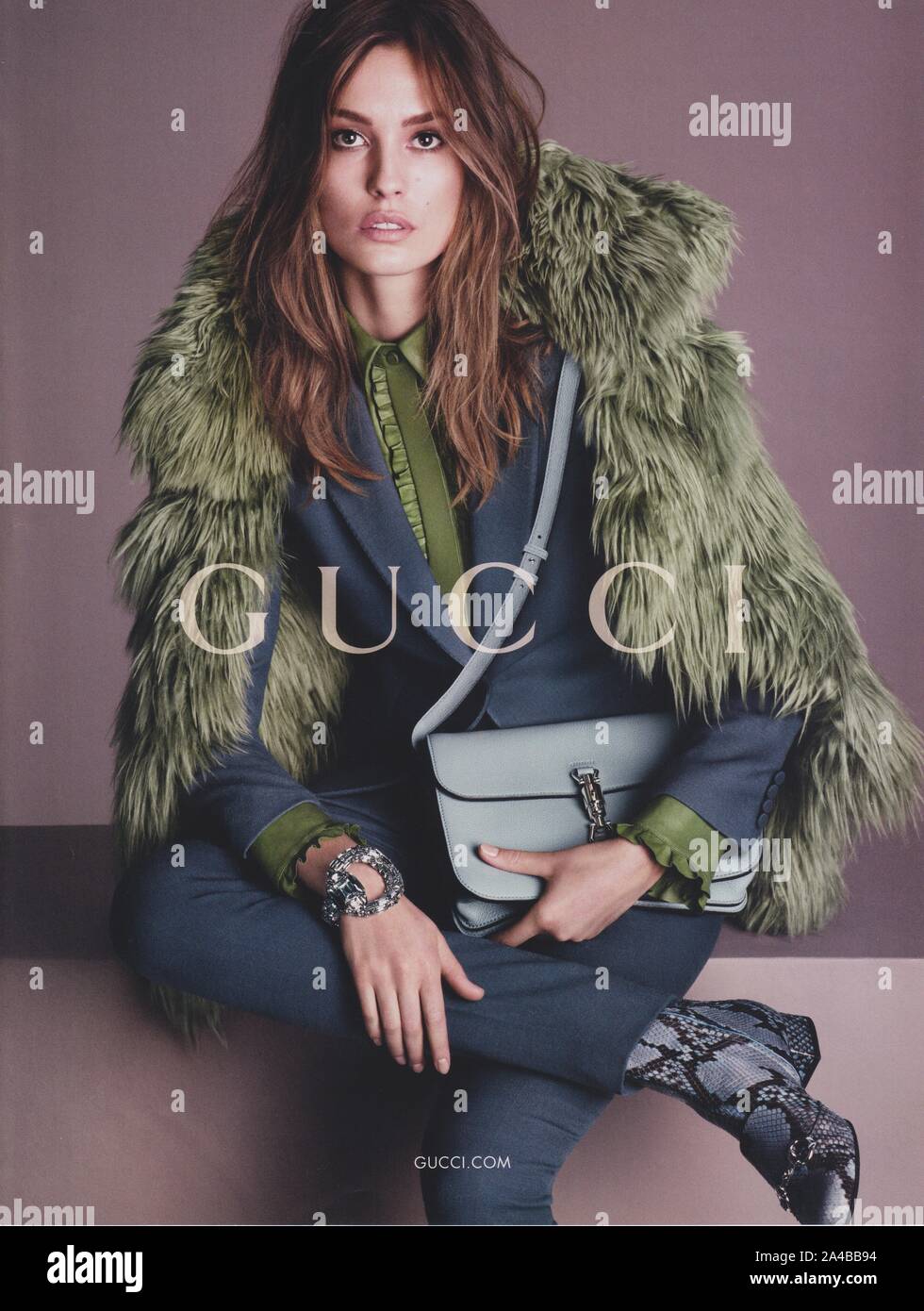 poster advertising GUCCI fashion house with Nadja Bender in paper magazine from 2014 year, advertisement, creative GUCCI advert from 2010s Stock Photo