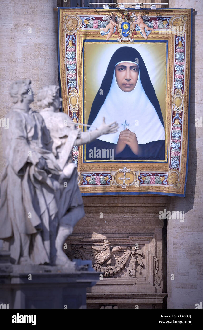 Vatican City, Vatican City. 13th Oct, 2019. Tapestry portraying Maria Teresa Chiramel Mankidiyan hangs from the façade of St. Peter's Basilica as Pope Francis celebrates Canonization Mass for Britain John Henry Newman, Italian Giuseppina Vannini, Indian Maria Teresa Chiramel Mankidiyan, Brazilian Dulce Lopes Pontes, and Swiss Margarita Bays on Sunday, October 13, 2019, in Saint Peter's Square at the Vatican. Photo by Sefano Spaziani/UPI Credit: UPI/Alamy Live News Stock Photo