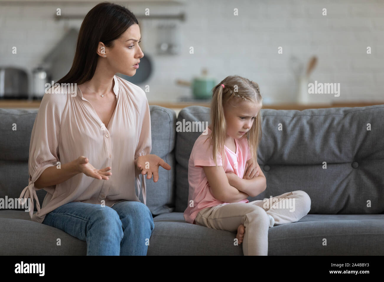Stubborn upset little daughter ignoring strict mother, family conflict Stock Photo