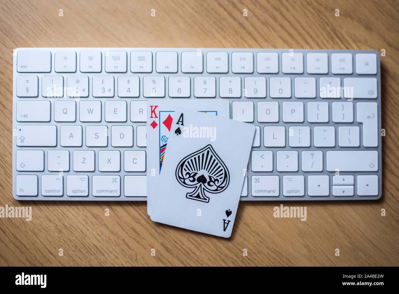 Online gambling and poker play concept with keyboard on a table showing king and ace cards Stock Photo