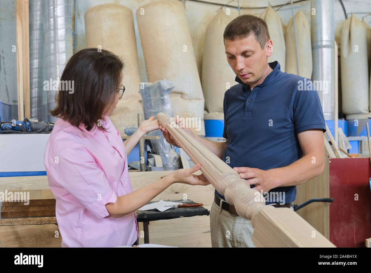 Industrial carpentry working man and woman discussing and