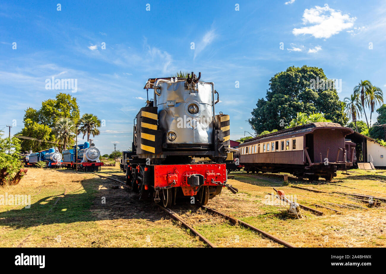 Old retro steel locomotive trains and wagons standing on the rails in Livingstone, Zambia Stock Photo