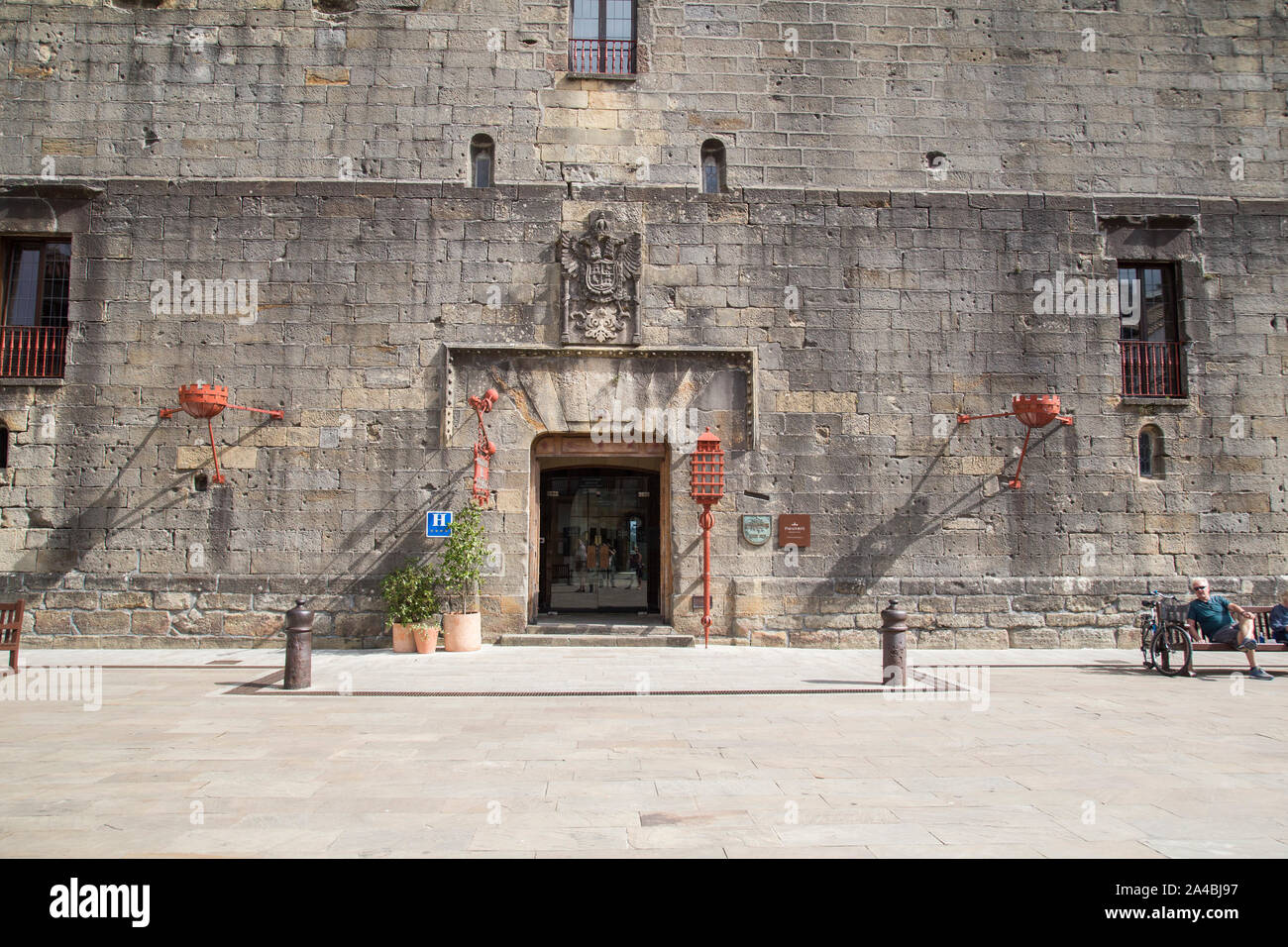 An ancient stone wall of a prison with marks from war. Stock Photo