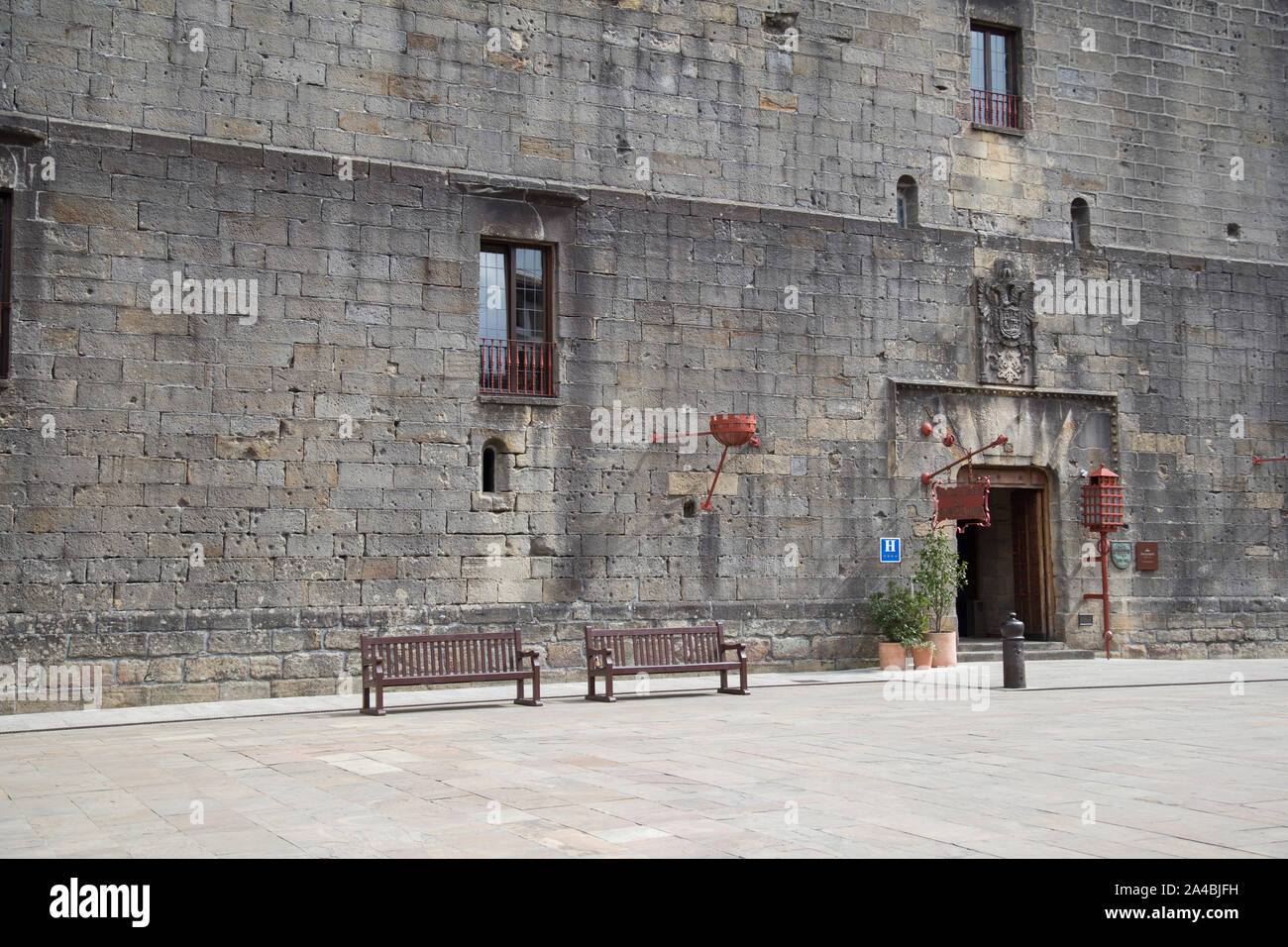 An ancient stone wall of a prison with marks from war. Stock Photo