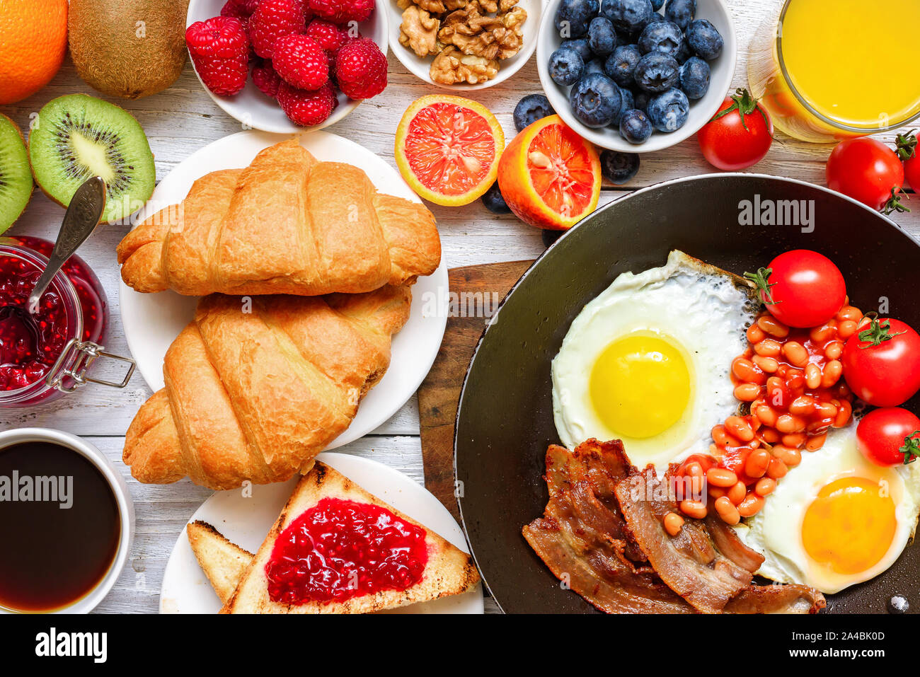 https://c8.alamy.com/comp/2A4BK0D/breakfast-buffet-full-continental-with-fried-eggs-bacon-fruits-toast-croissants-berries-coffee-and-orange-juice-top-view-2A4BK0D.jpg