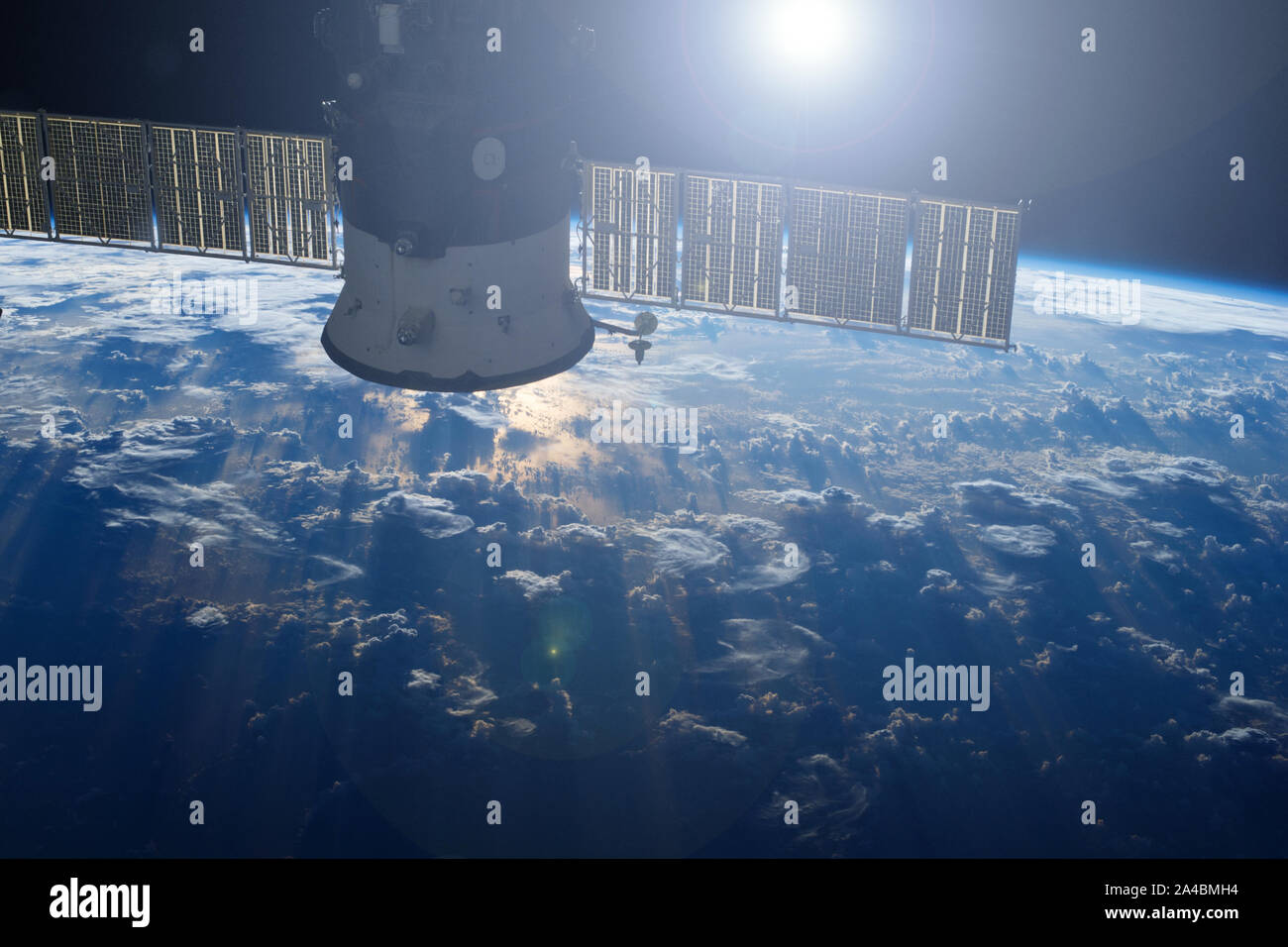 Space satellite above the earth, with reflection of the sun.Elements of this image were furnished by NASA Stock Photo