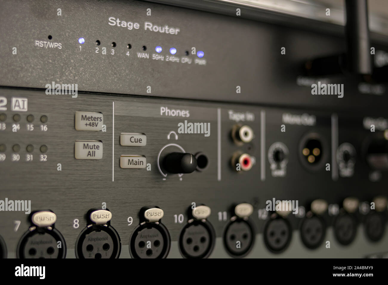 Set of audio inputs on a stage mixer with headphone output, phantom power buttons and stage router status LEDs Stock Photo