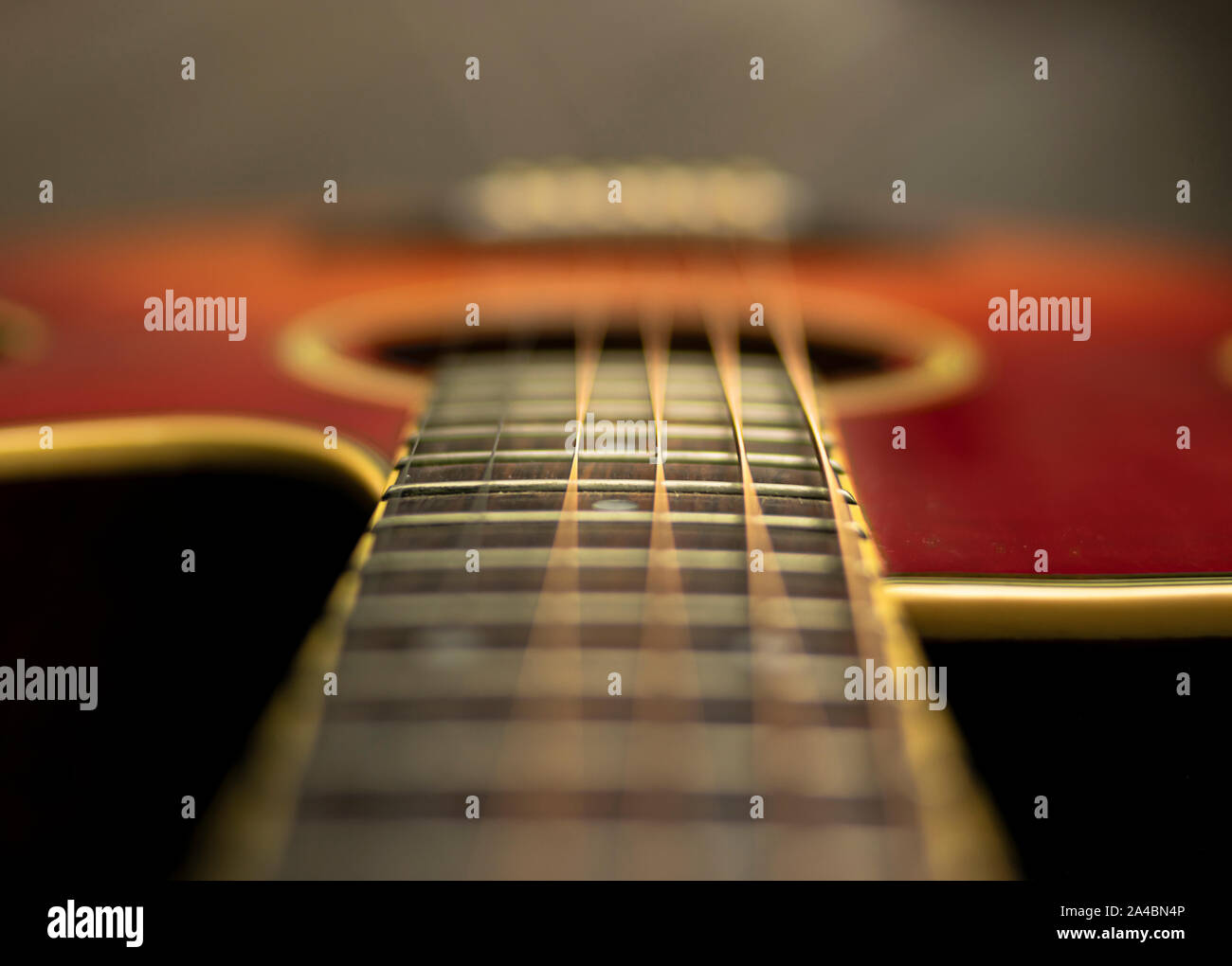 Shot from the neck of the acoustic guitar with focus on the fifteenth fret Stock Photo