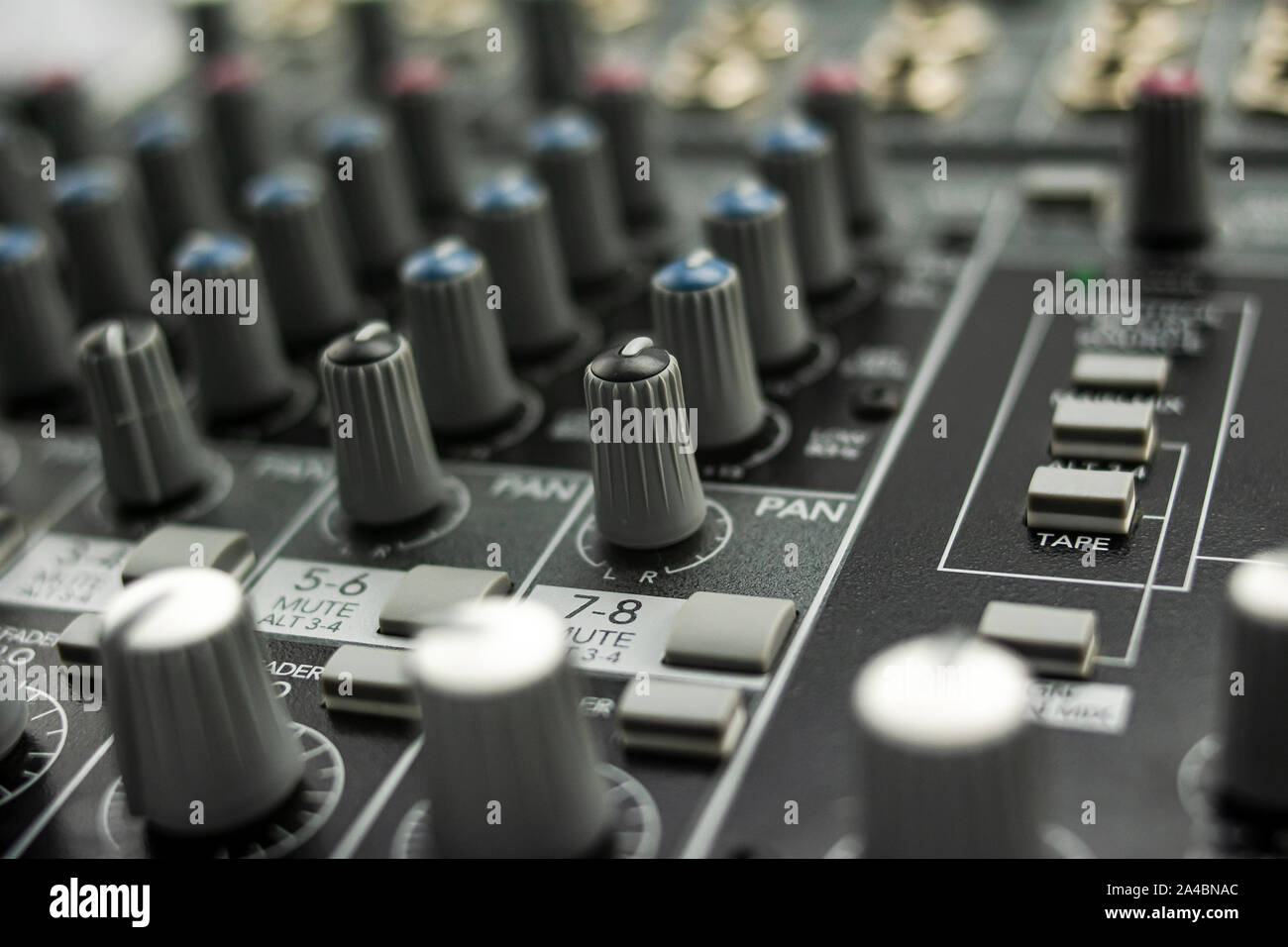 Inputs, equalization and panning on an analog mixing console, with its knobs, keypads and regulators prepared for use it Stock Photo