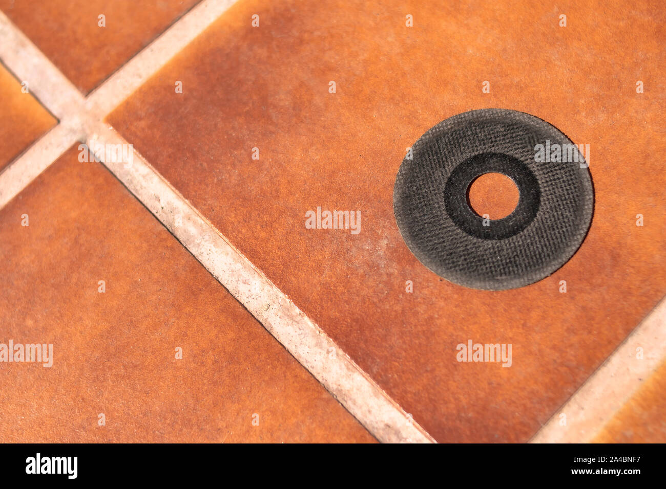 Cutting disc of a radial prepared for installation and shown on clay soil in the inner courtyard Stock Photo